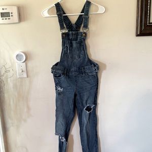 Dark jean. Sturdy material. Overalls with rips.